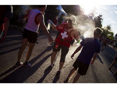 The medical team sprays racers with a mist of water just after the 10K finish line.