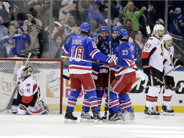 Ottawa Senators goalie Craig Anderson (41) and teammate Ben Harpur (67) look away as the New York Rangers celebrate a goal by Michael Grabner during the first period of Game 3 of an NHL hockey Stanley Cup second-round playoff series Tuesday, May 2, 2017, in New York.