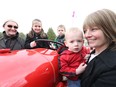 Michael Thompson will drive his tractor across Ontario in the hopes of raising money for Jillian O'Connor's kids' education, May 10, 2017.  The kids, Myla (2nd for L), Landon (m) and Declan (2nd for R) have fun looking at the tractor that Michael Thompson (L) will be driving around Ontario to raise money for their mother, Jillian O'Connor (R)  who has breast cancer.  Jillian has breast cancer.   Photo by Jean Levac
