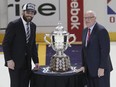 Mike Fisher, in street clothes because an injury sidelined him from Monday's game, accepts the Clarence S. Campbell Bowl from 
NHL deputy commissioner Bill Daly, right, after the Predators beat the Ducks to clinch a berth in the Stanley Cup final.