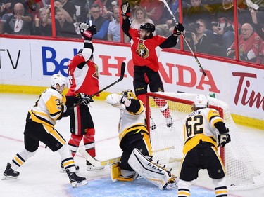 Ottawa Senators left wing Mike Hoffman (68) and left wing Alex Burrows (14) celebrates Hoffman's goal as Pittsburgh Penguins goalie Marc-Andre Fleury (29) defenceman Olli Maatta (3) and left wing Carl Hagelin (62) look on during the first period of game three of the Eastern Conference final in the NHL Stanley Cup hockey playoffs in Ottawa on Wednesday, May 17, 2017.