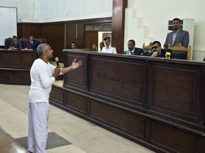 In this May 3, 2014 file photo, Canadian acting Al-Jazeera bureau chief Mohammed Fahmy talks to the judge in a courthouse near Tora prison along with several other defendants during their trial on terror charges in Cairo, Egypt.