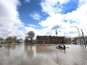 Gatineau emergency workers helped the people of Rue Saint-Louis in Gatineau Wednesday May 3, 2017. More rain has caused water to rise and flooded more people out of their homes. Imad Barhouch pushes his neighbours back to their homes after they moved their cars to higher land Wednesday.