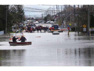 Gatineau emergency workers helped the people of Rue Saint-Louis in Gatineau Wednesday May 3, 2017. More rain has caused water to rise and flooded more people out of their homes. Home owners float down Rue Saint-Louis in Gatineau with a boat Wednesday looking for people who need help.