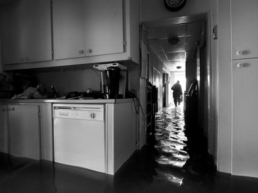 Water is starting to drop around Rue Saint-Louis in Gatineau Tuesday May 9, 2017. Home owners around the Gatineau area can only wait until the water goes away before the clean up can begin. Sylvie Lavoie was upset after seeing her water filled house on Rue Jacques-Cartier in Gatineau Tuesday. Sylvie leaves her home Tuesday.