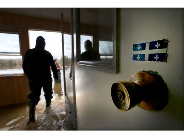 Water is starting to drop around Rue Saint-Louis in Gatineau Tuesday May 9, 2017. Home owners around the Gatineau area can only wait until the water goes away before the cleanup can begin. Sylvie Lavoie was upset after seeing her water filled house on Rue Jacques-Cartier in Gatineau Tuesday. Sylvie and Gilles leave  their home Tuesday.