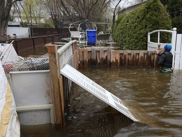 Water is starting to drop around Rue Saint-Louis in Gatineau Tuesday May 9, 2017. Home owners around the Gatineau area can only wait until the water goes away before the clean up can begin. Gilles Robertson looks into his back yard on Rue Jacques-Cartier in Gatineau Tuesday. The couple were visiting their house trying salvage anything on the destroyed first floor.