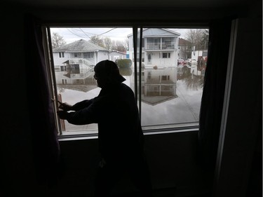 Water is starting to drop around Rue Saint-Louis in Gatineau Tuesday May 9, 2017. Home owners around the Gatineau area can only wait until the water goes away before the clean up can begin. Daniel Doucet has seven feet of water in his basement on Rue St-Francois-Xavier. Daniel visits his home by boat Tuesday and locks up before leaving.