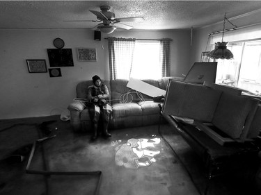 Water is starting to drop around Rue Saint-Louis in Gatineau Tuesday May 9, 2017. Home owners around the Gatineau area can only wait until the water goes away before the clean up can begin. Sylvie Lavoie sits in her water filled living room on Rue Jacques-Cartier in Gatineau Tuesday. The couple were visiting their house trying salvage anything on the destroyed first floor.