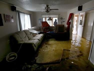 Water is starting to drop around Rue Saint-Louis in Gatineau Tuesday May 9, 2017. Home owners around the Gatineau area can only wait until the water goes away before the clean up can begin. Sylvie Lavoie was upset after seeing her water filled house on Rue Jacques-Cartier in Gatineau Tuesday. The couple were visiting their house trying salvage anything on the destroyed first floor.