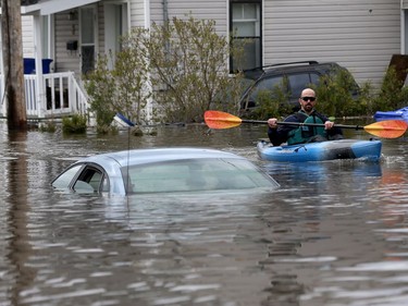 Water is starting to drop around Rue Saint-Louis in Gatineau Tuesday May 9, 2017. Home owners around the Gatineau area can only wait until the water goes away before the clean up can begin. Boater on Rue Rene  Tuesday.