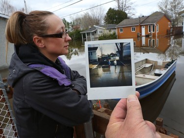 Water is starting to drop around Rue Saint-Louis in Gatineau Tuesday May 9, 2017. Home owners around the Gatineau area can only wait until the water goes away before the clean up can begin. Marelyn Gosselin was shocked to see how much water was in her dad's house on Rue St-Francois-Xavier Tuesday. Photos of Marelyn and her sister Isabelle fishing on their street during a flood 22 years ago.