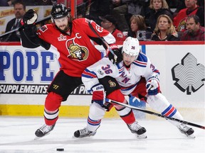 Senators captain Erik Karlsson battles for a loose puck against Mats Zuccarello in Game 5.