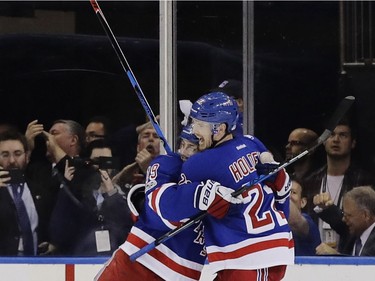 New York Rangers' Nick Holden (22) and Jesper Fast (19) celebrate after Holden scored a goal during the first period of Game 4 of an NHL hockey Stanley Cup second-round playoff series against the Ottawa Senators, Thursday, May 4, 2017, in New York.