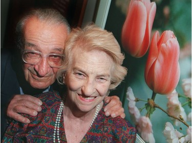 Ottawa-05/16/01-Ottawa photographer Malak Karsh poses with his two loves: tulips and his wife, Barbara, at an exhibition of his work at the Casino de Hull.
