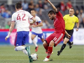 Fury FC's Sito Seoane, right, kicks the ball past Toronto FC's Mitch Taintor (42) during the first half at TD Place stadium on Tuesday night. Sito would score the winning goal in the second half of the contest. Darren Brown/Postmedia