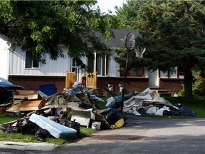 July 28, 2009 — Personal belongings out near the road on Dudegan street, where sewage backed-up into residents' basements following a heavy Friday downpour in Kanata.