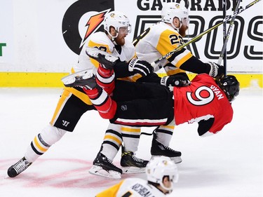 Ottawa Senators right wing Bobby Ryan (9) is checked by Pittsburgh Penguins centre Scott Wilson (23) and Penguins defenceman Ian Cole (28) during the first period of game six of the Eastern Conference final in the NHL Stanley Cup hockey playoffs in Ottawa on Tuesday, May 23, 2017.