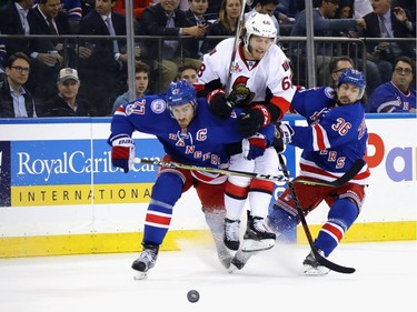 Mike Hoffman #68 of the Ottawa Senators attempts to get past Ryan McDonagh #27 and Mats Zuccarello #36 of the New York Rangers during the first period in Game Four of the Eastern Conference Second Round during the 2017 NHL Stanley Cup Playoffs at Madison Square Garden on May 4, 2017 in New York City.