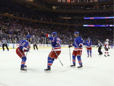 (L-R) Tanner Glass #15, Oscar Lindberg #24 and J.T. Miller #10 of the New York Rangers celebrate Lindberg's goal at 15:54 of the second period against the Ottawa Senators in Game Four of the Eastern Conference Second Round during the 2017 NHL Stanley Cup Playoffs at Madison Square Garden on May 4, 2017 in New York City.