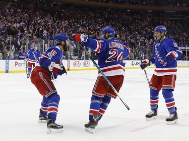 NEW YORK, NY - MAY 04:  (L-R) Tanner Glass #15, Oscar Lindberg #24 and J.T. Miller #10 of the New York Rangers celebrate Lindberg's goal at 15:54 of the second period against the Ottawa Senators in Game Four of the Eastern Conference Second Round during the 2017 NHL Stanley Cup Playoffs at Madison Square Garden on May 4, 2017 in New York City.