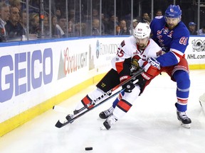 Erik Karlsson #65 of the Ottawa Senators and Rick Nash #61 of the New York Rangers skate for the puck during the second period in Game Six of the Eastern Conference Second Round during the 2017 NHL Stanley Cup Playoffs at Madison Square Garden on May 9, 2017 in New York City.