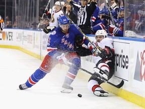 Brendan Smith #42 of the New York Rangers checks Cody Ceci #5 of the Ottawa Senators into the boards during the third period in Game Three of the Eastern Conference Second Round during the 2017 NHL Stanley Cup Playoffs at Madison Square Garden on May 2, 2017 in New York City. The Rangers defeated the Senators 4-1.