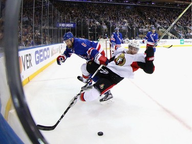 NEW YORK, NY - MAY 02:Tommy Wingels #57 of the Ottawa Senators is checked by Dan Girardi #5 of the New York Rangers during the first period in Game Three of the Eastern Conference Second Round during the 2017 NHL Stanley Cup Playoffs at Madison Square Garden on May 2, 2017 in New York City.