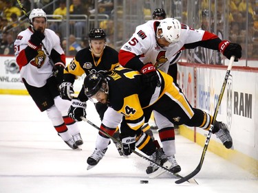 PITTSBURGH, PA - MAY 21:  Chris Kunitz #14 of the Pittsburgh Penguins falls to the ice against Cody Ceci #5 of the Ottawa Senators in Game Five of the Eastern Conference Final during the 2017 NHL Stanley Cup Playoffs at PPG PAINTS Arena on May 21, 2017 in Pittsburgh, Pennsylvania.