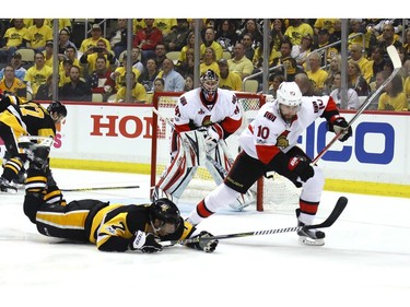 Matt Cullen of the Pittsburgh Penguins dives to the ice against Tom Pyatt of the Ottawa Senators.