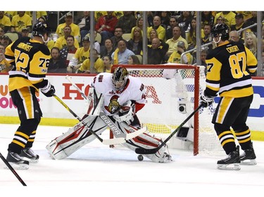 Craig Anderson makes a save with Sidney Crosby and Patric Hornqvist ready to pounce.