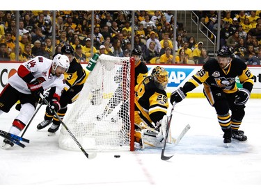 Alex Burrows of the Ottawa Senators brings the puck around the net.