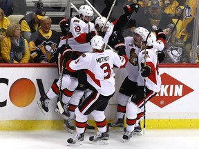 Bobby Ryan of the Ottawa Senators celebrates with his teammates after scoring an overtime goal against Marc-Andre Fleury #29 of the Pittsburgh Penguins in Game 1 of the Eastern Conference final.