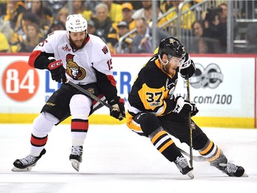 Carter Rowney #37 of the Pittsburgh Penguins fights for the puck against Zack Smith #15 of the Ottawa Senators during the first period in Game Seven of the Eastern Conference Final during the 2017 NHL Stanley Cup Playoffs at PPG PAINTS Arena on May 25, 2017 in Pittsburgh, Pennsylvania.