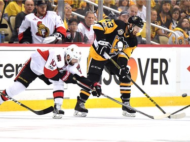 Nick Bonino #13 of the Pittsburgh Penguins fights for the puck against Tom Pyatt #10 of the Ottawa Senators during the first period in Game Seven of the Eastern Conference Final during the 2017 NHL Stanley Cup Playoffs at PPG PAINTS Arena on May 25, 2017 in Pittsburgh, Pennsylvania.