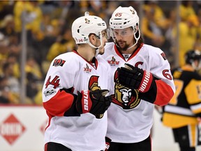 Jean-Gabriel Pageau #44 and Erik Karlsson #65 of the Ottawa Senators talk during a break in play against the Pittsburgh Penguins in Game Seven of the Eastern Conference Final during the 2017 NHL Stanley Cup Playoffs at PPG PAINTS Arena on May 25, 2017 in Pittsburgh, Pennsylvania.