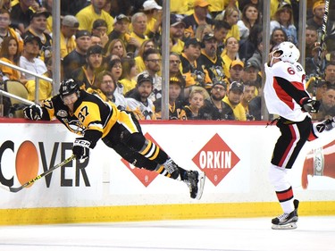 Carter Rowney #37 of the Pittsburgh Penguins falls to the ice against Mark Stone #61 of the Ottawa Senators during the third period in Game Seven of the Eastern Conference Final during the 2017 NHL Stanley Cup Playoffs at PPG PAINTS Arena on May 25, 2017 in Pittsburgh, Pennsylvania.