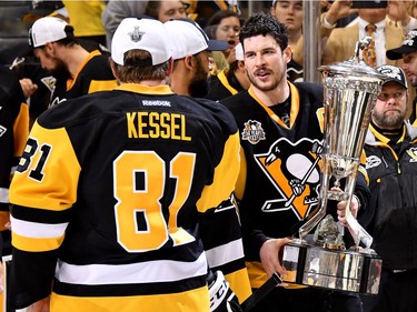 PITTSBURGH, PA - MAY 25:  Sidney Crosby #87 of the Pittsburgh Penguins talks with Phil Kessel #81 as he holds the Prince of Wales Trophy after winning Game Seven of the Eastern Conference Final against the Ottawa Senators during the 2017 NHL Stanley Cup Playoffs at PPG PAINTS Arena on May 25, 2017 in Pittsburgh, Pennsylvania. The Pittsburgh Penguins defeated the Ottawa Senators with a score of 3 to 2.