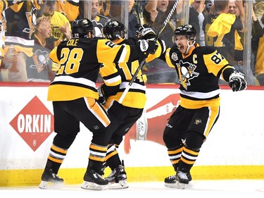 PITTSBURGH, PA - MAY 25:  Chris Kunitz #14 of the Pittsburgh Penguins celebrates with Sidney Crosby #87 and Ian Cole #28 after scoring a goal agianst Craig Anderson #41 of the Ottawa Senators in the second overtime with a score of 3 to 2 in Game Seven of the Eastern Conference Final during the 2017 NHL Stanley Cup Playoffs at PPG PAINTS Arena on May 25, 2017 in Pittsburgh, Pennsylvania.