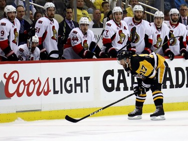 Bryan Rust #17 of the Pittsburgh Penguins skates back to the bench after being hit by Dion Phaneuf #2 of the Ottawa Senators during the first period in Game Two of the Eastern Conference Final during the 2017 NHL Stanley Cup Playoffs at PPG PAINTS Arena on May 15, 2017 in Pittsburgh, Pennsylvania.