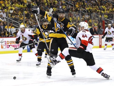 Ron Hainsey #65 of the Pittsburgh Penguins hits Jean-Gabriel Pageau #44 of the Ottawa Senators during the first period in Game Two of the Eastern Conference Final during the 2017 NHL Stanley Cup Playoffs at PPG PAINTS Arena on May 15, 2017 in Pittsburgh, Pennsylvania.