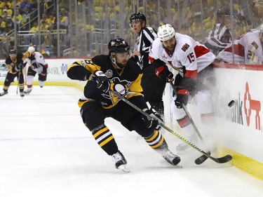 Brian Dumoulin #8 of the Pittsburgh Penguins fights for the puck against Zack Smith #15 of the Ottawa Senators in Game Two of the Eastern Conference Final during the 2017 NHL Stanley Cup Playoffs at PPG PAINTS Arena on May 15, 2017 in Pittsburgh, Pennsylvania.