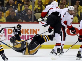 Dion Phaneuf #2 of the Ottawa Senators hits Bryan Rust #17 of the Pittsburgh Penguins during the first period in Game Two of the Eastern Conference Final during the 2017 NHL Stanley Cup Playoffs at PPG PAINTS Arena on May 15, 2017 in Pittsburgh, Pennsylvania.