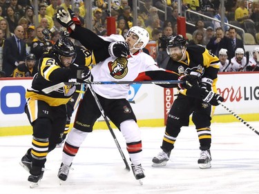 Ron Hainsey #65 of the Pittsburgh Penguins hits Jean-Gabriel Pageau #44 of the Ottawa Senators during the first period in Game Two of the Eastern Conference Final during the 2017 NHL Stanley Cup Playoffs at PPG PAINTS Arena on May 15, 2017 in Pittsburgh, Pennsylvania.