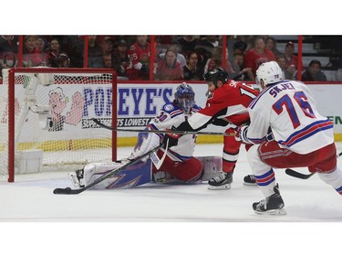 The Senators' Zack Smith tries to score on New York Rangers goalie Henrik Lundqvist.