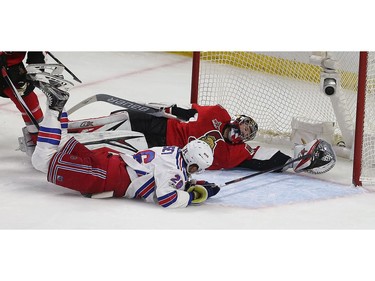 Ottawa Senators goalie Craig Anderson tries to stop the puck from crossing the goal line during the third period. The Rangers' Jimmy Vesey scores on the play.