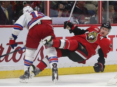 The Ottawa Senators' Dion Phaneuf gets hit by the New York Rangers; Tanner Glass.