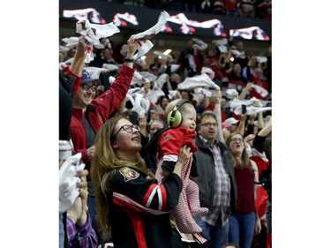 A young Senators fan came prepared, wearing ear protection as the crowd erupts.