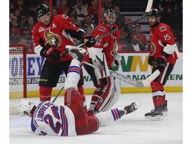 The Ottawa Senators' Dion Phaneuf dumps the New York Rangers' Oscar Lindberg.