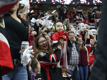A young Senators fan came prepared, wearing ear protection as the crowd erupts.